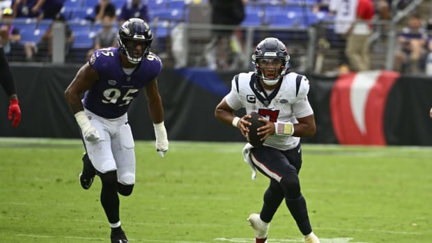 Houston Texans quarterback C.J. Stroud (7) carries the ball as Baltimore Ravens linebacker Tavius Robinson (95) chases during the second half at M&T Bank Stadium.
